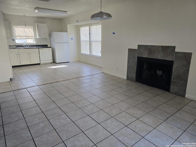 kitchen with open floor plan, white appliances, dark countertops, and white cabinets