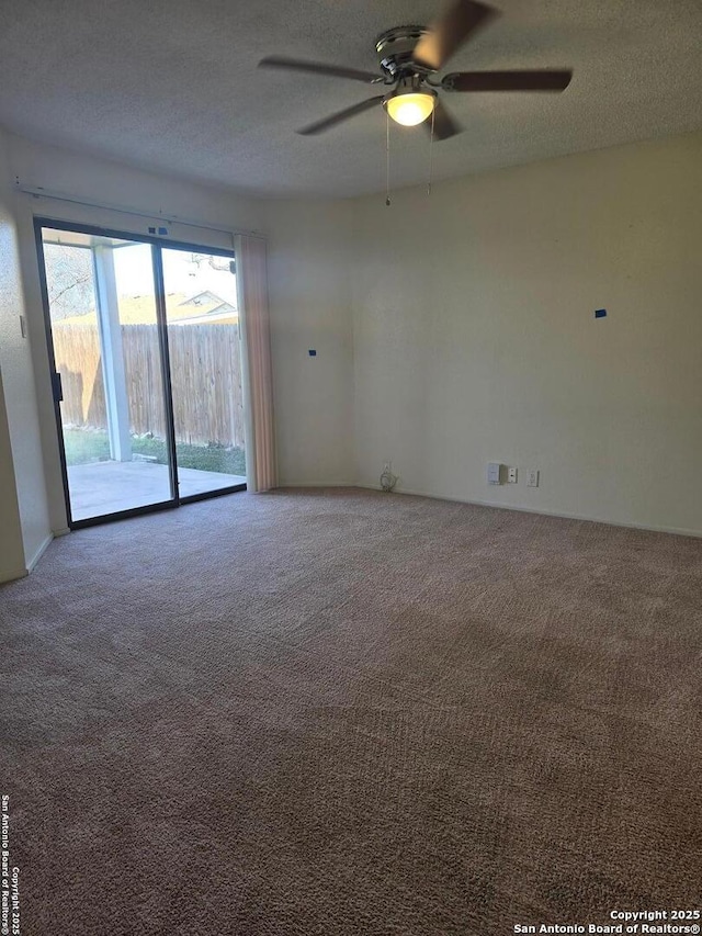 empty room featuring carpet floors, ceiling fan, and a textured ceiling