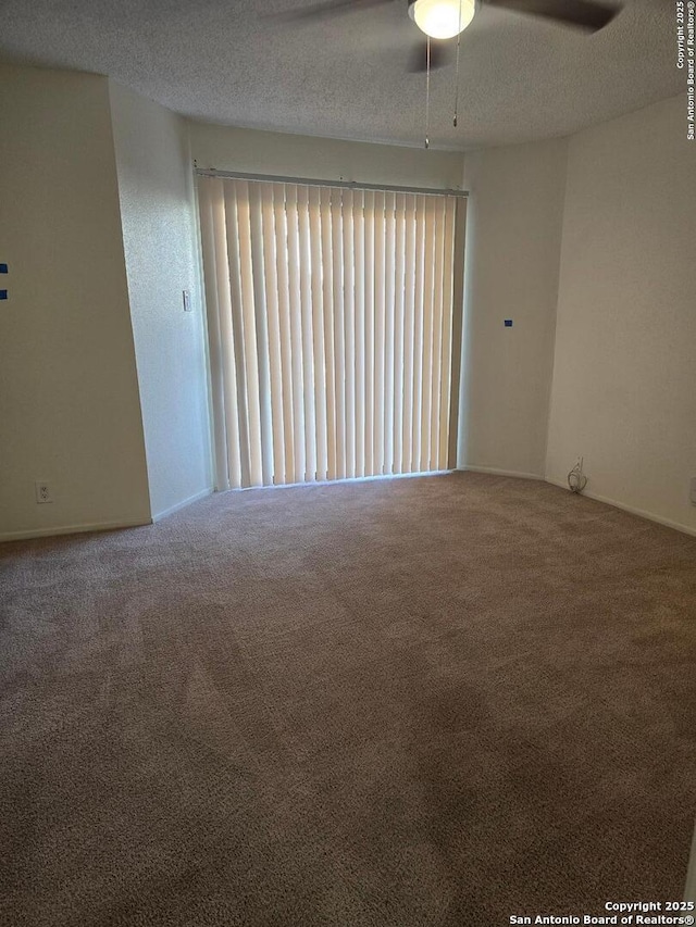 empty room with carpet, ceiling fan, and a textured ceiling