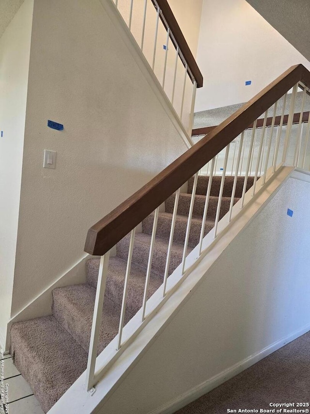 staircase featuring baseboards