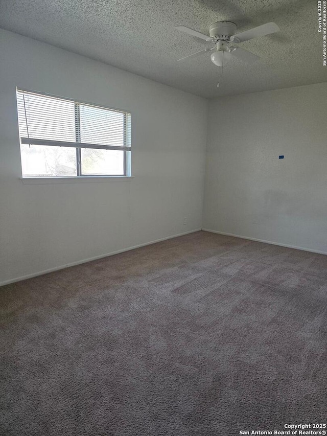 carpeted spare room with ceiling fan and a textured ceiling