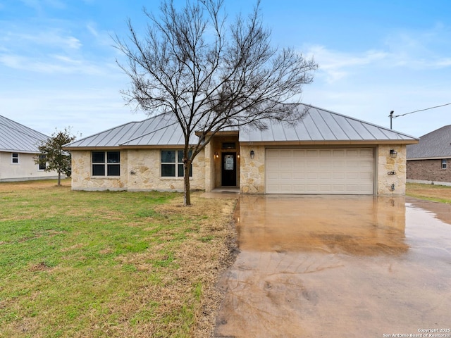 view of front of home with concrete driveway, stone siding, metal roof, a standing seam roof, and a front yard