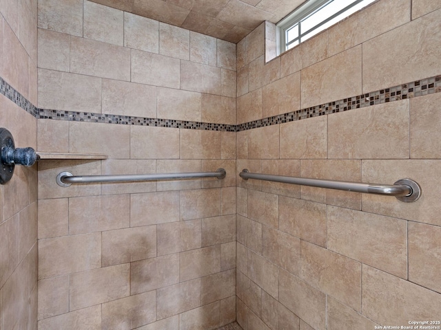 interior details with a tile shower