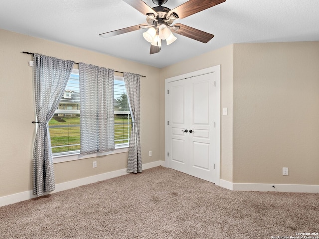 unfurnished bedroom featuring carpet flooring and baseboards