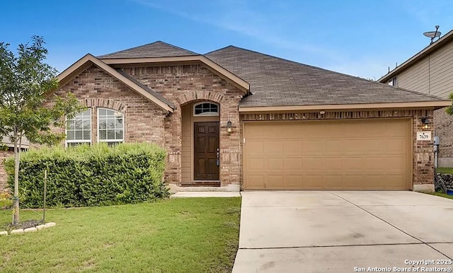 french country inspired facade with an attached garage, brick siding, and a front yard