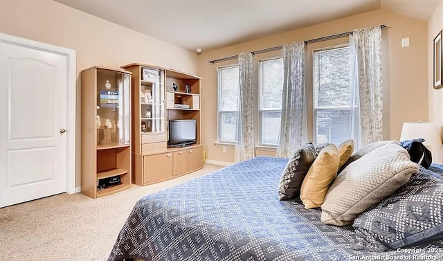 bedroom featuring light carpet