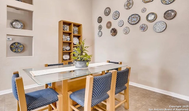 dining space with tile patterned flooring and baseboards