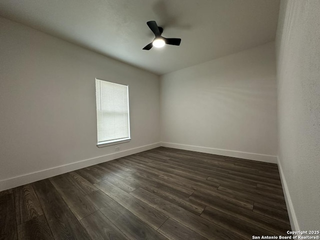 unfurnished room featuring a ceiling fan, baseboards, and dark wood-style flooring