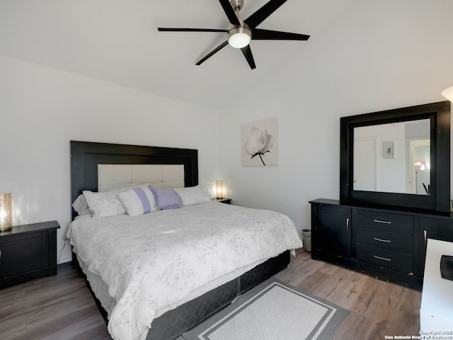 bedroom with lofted ceiling, wood finished floors, and a ceiling fan