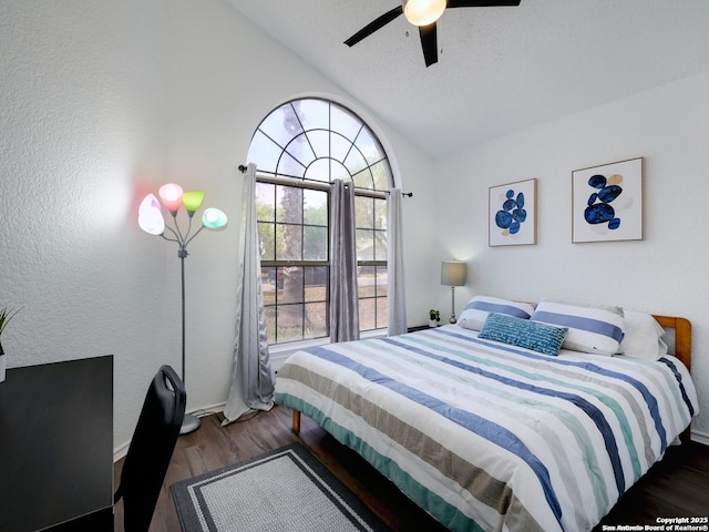 bedroom with vaulted ceiling, ceiling fan, and dark wood-type flooring