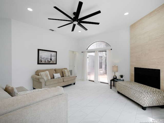 living area featuring marble finish floor, visible vents, a ceiling fan, and recessed lighting