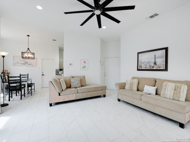 living room featuring ceiling fan with notable chandelier, visible vents, and recessed lighting