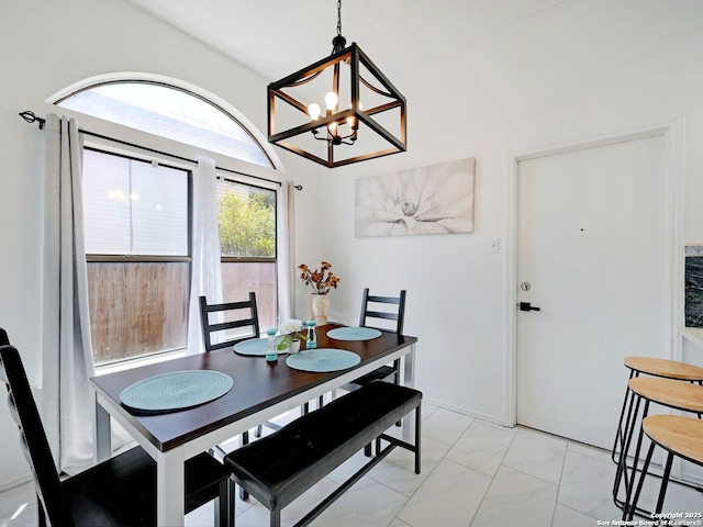 dining area with marble finish floor and a notable chandelier