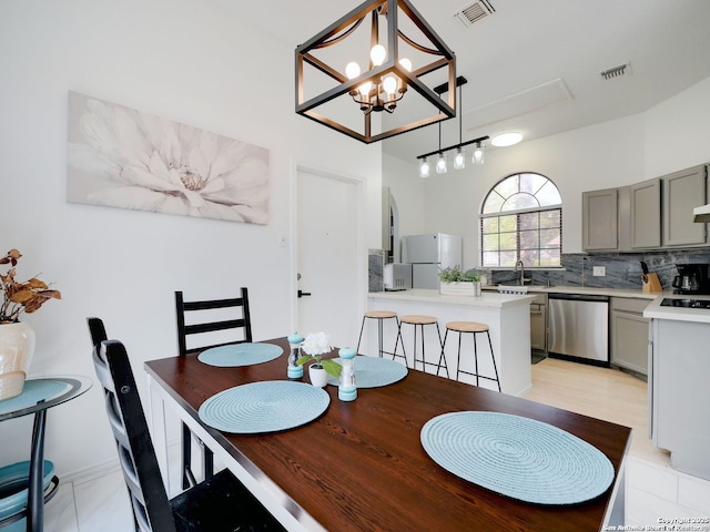 dining room featuring visible vents and a notable chandelier