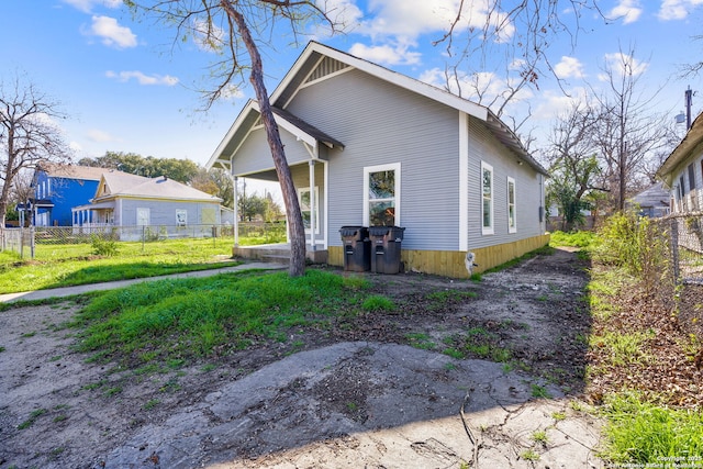 view of front of home featuring fence