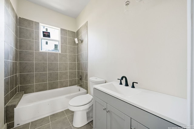 bathroom with washtub / shower combination, toilet, vanity, and tile patterned floors