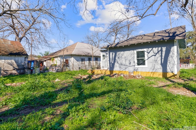 rear view of property featuring fence