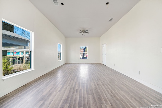 spare room featuring light wood-style floors, baseboards, and visible vents