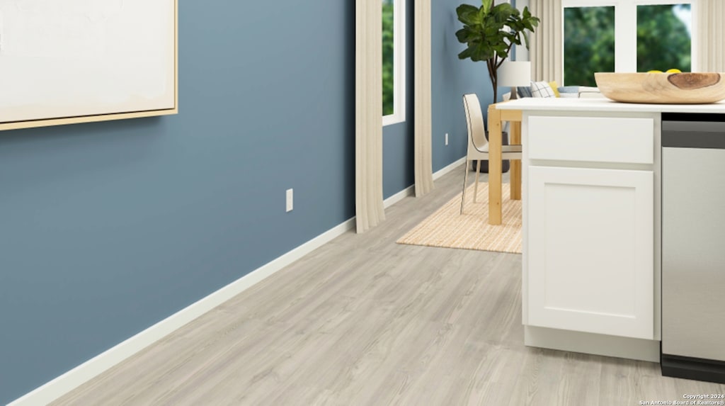 interior space with light wood finished floors and baseboards