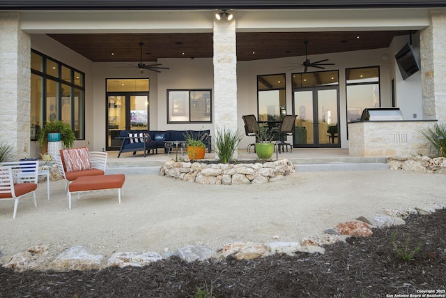 exterior space with a patio area, outdoor lounge area, a ceiling fan, and stucco siding