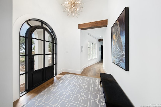 foyer entrance with recessed lighting, a notable chandelier, baseboards, and wood finished floors