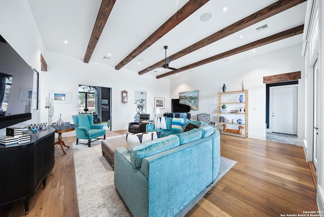 living area featuring recessed lighting, visible vents, baseboards, light wood-style floors, and beamed ceiling