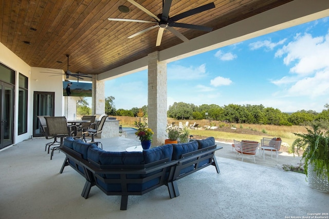 view of patio / terrace featuring ceiling fan, an outdoor kitchen, outdoor dining space, and outdoor lounge area