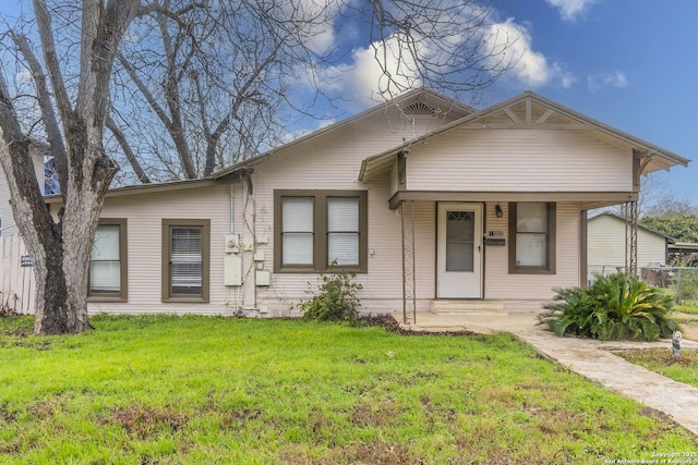 bungalow-style house with covered porch and a front lawn