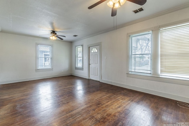 entrance foyer featuring dark wood-style flooring, a ceiling fan, baseboards, visible vents, and crown molding