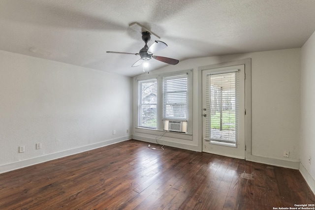 unfurnished room featuring dark wood-style floors, vaulted ceiling, a textured ceiling, and a ceiling fan