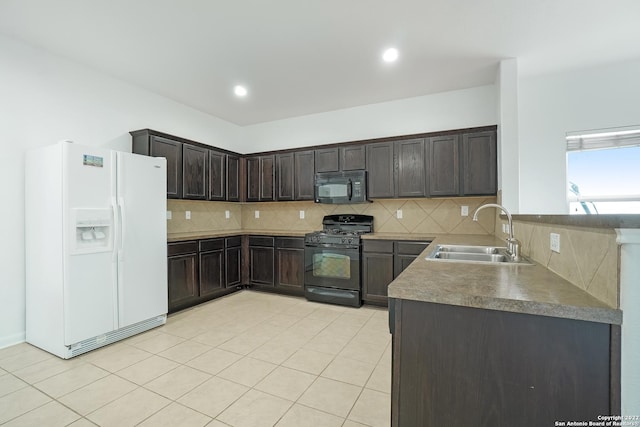 kitchen with dark brown cabinetry, black appliances, backsplash, and a sink