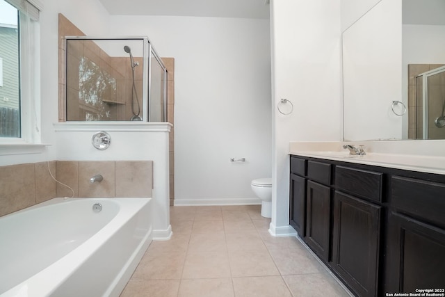 full bathroom with a stall shower, toilet, a garden tub, tile patterned flooring, and vanity