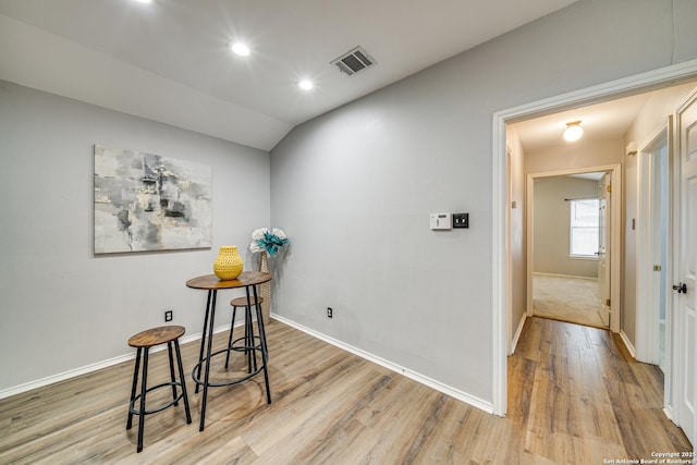 dining room with lofted ceiling, recessed lighting, wood finished floors, visible vents, and baseboards