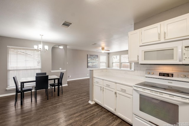 kitchen featuring decorative light fixtures, light countertops, visible vents, white cabinetry, and white appliances