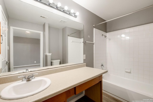 full bathroom with toilet, visible vents, tub / shower combination, and vanity