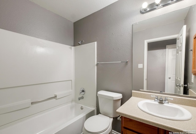 full bathroom featuring toilet, shower / bathtub combination, vanity, and a textured wall