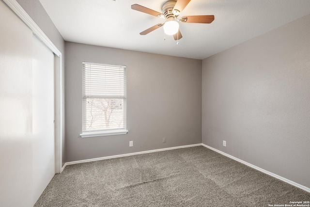 spare room featuring carpet floors, baseboards, and a ceiling fan