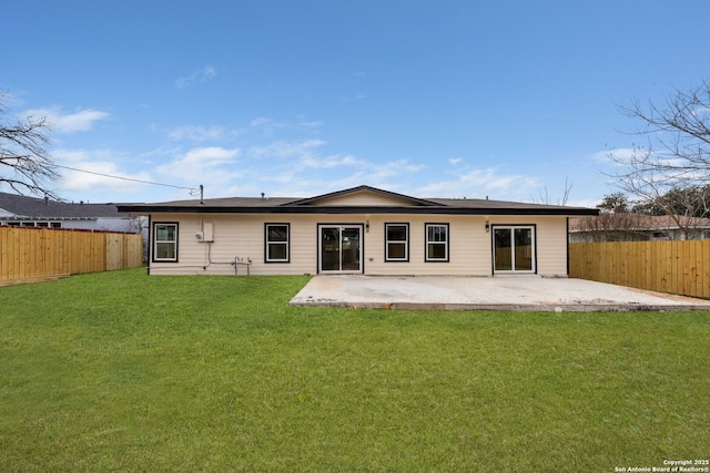 rear view of property featuring a patio area, a fenced backyard, and a yard