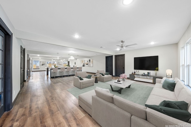 living area with recessed lighting, a healthy amount of sunlight, and wood finished floors