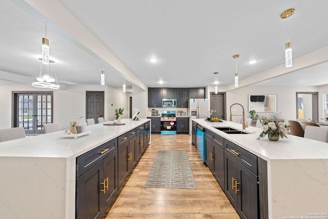 kitchen featuring pendant lighting, a sink, and a large island