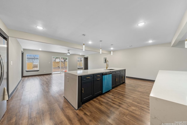 kitchen with a sink, open floor plan, light countertops, stainless steel dishwasher, and an island with sink