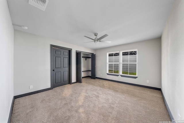 unfurnished bedroom featuring a ceiling fan, carpet flooring, visible vents, and baseboards