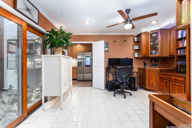 home office featuring ceiling fan, built in desk, a wealth of natural light, and crown molding