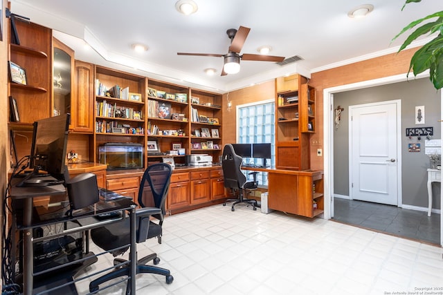 home office with a ceiling fan, baseboards, visible vents, and crown molding