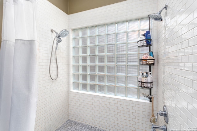 full bathroom with a tile shower