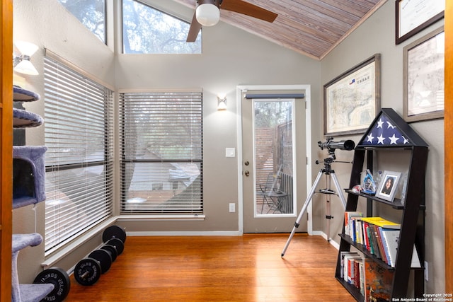 interior space with vaulted ceiling, wooden ceiling, wood finished floors, and a healthy amount of sunlight