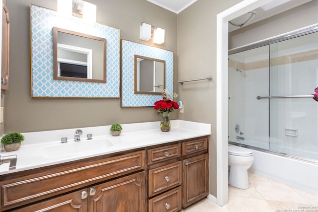 full bath featuring vanity, shower / bath combination with glass door, tile patterned flooring, and toilet