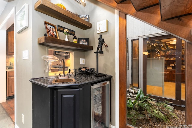 bar featuring wine cooler, a sink, and wet bar