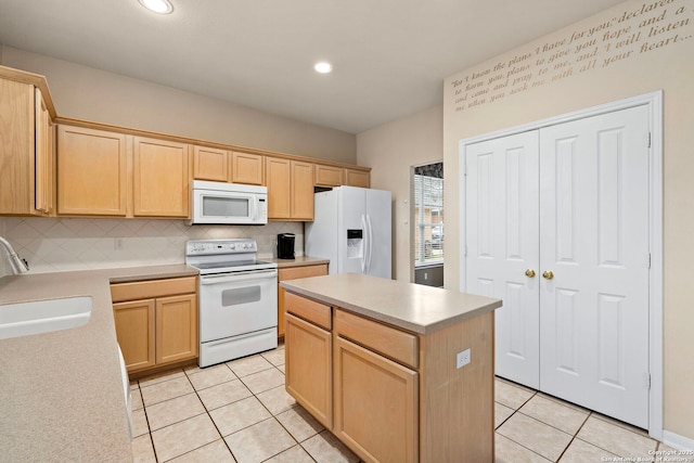 kitchen featuring light tile patterned floors, white appliances, a sink, light countertops, and a center island