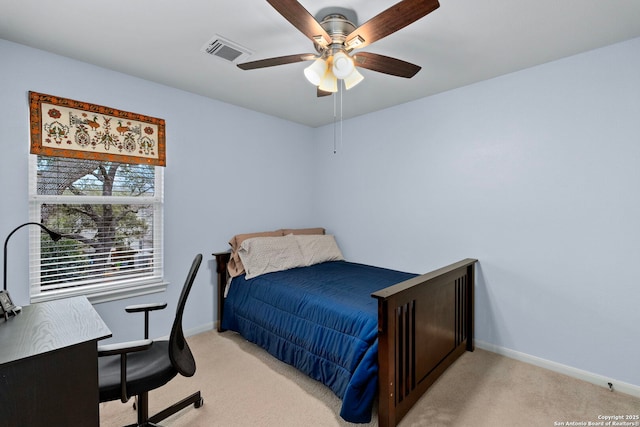 bedroom featuring baseboards, visible vents, ceiling fan, and light colored carpet